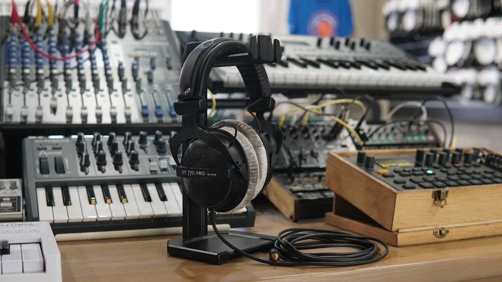 a table with a bunch of headphones on top of it