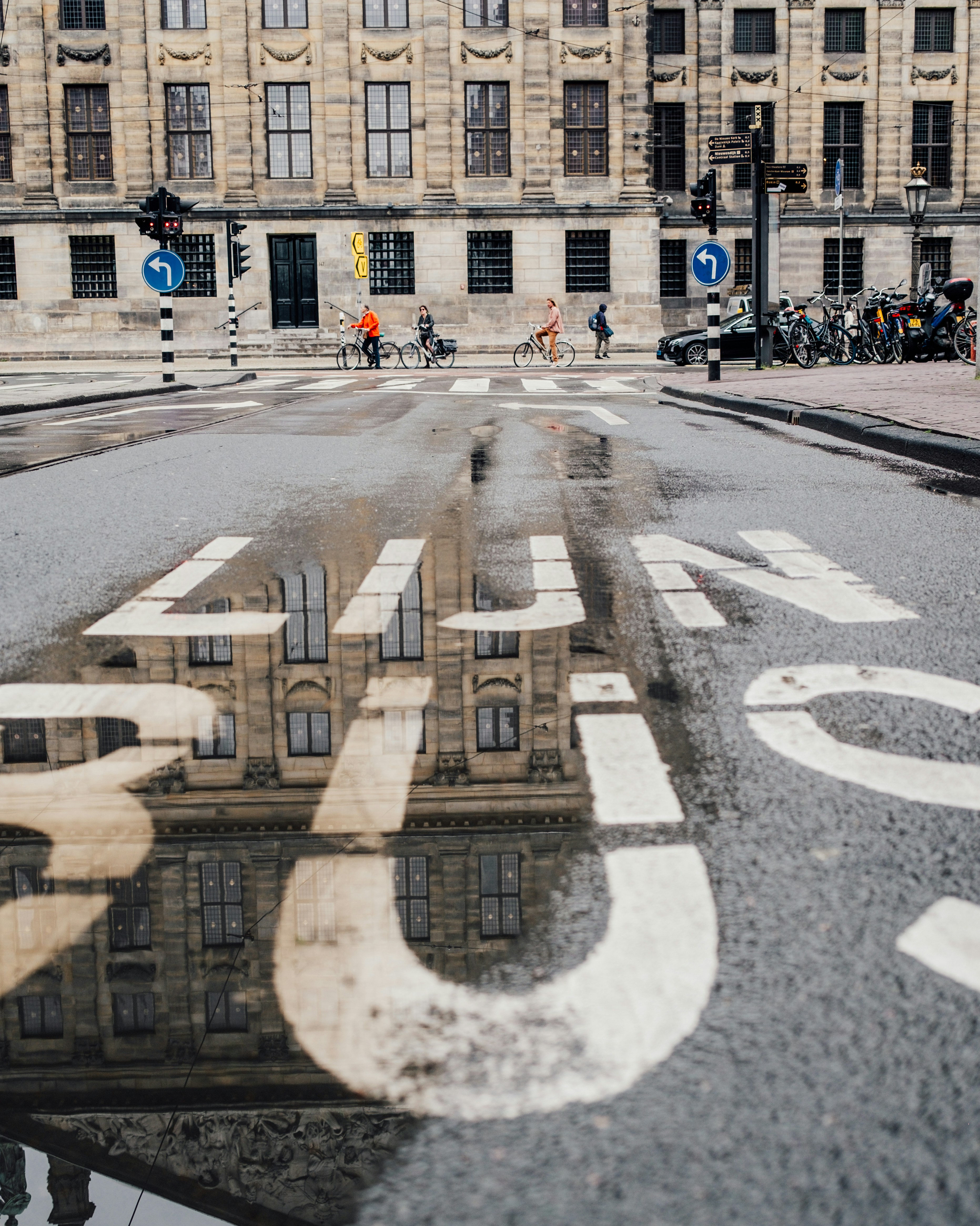a reflection of a building in a puddle