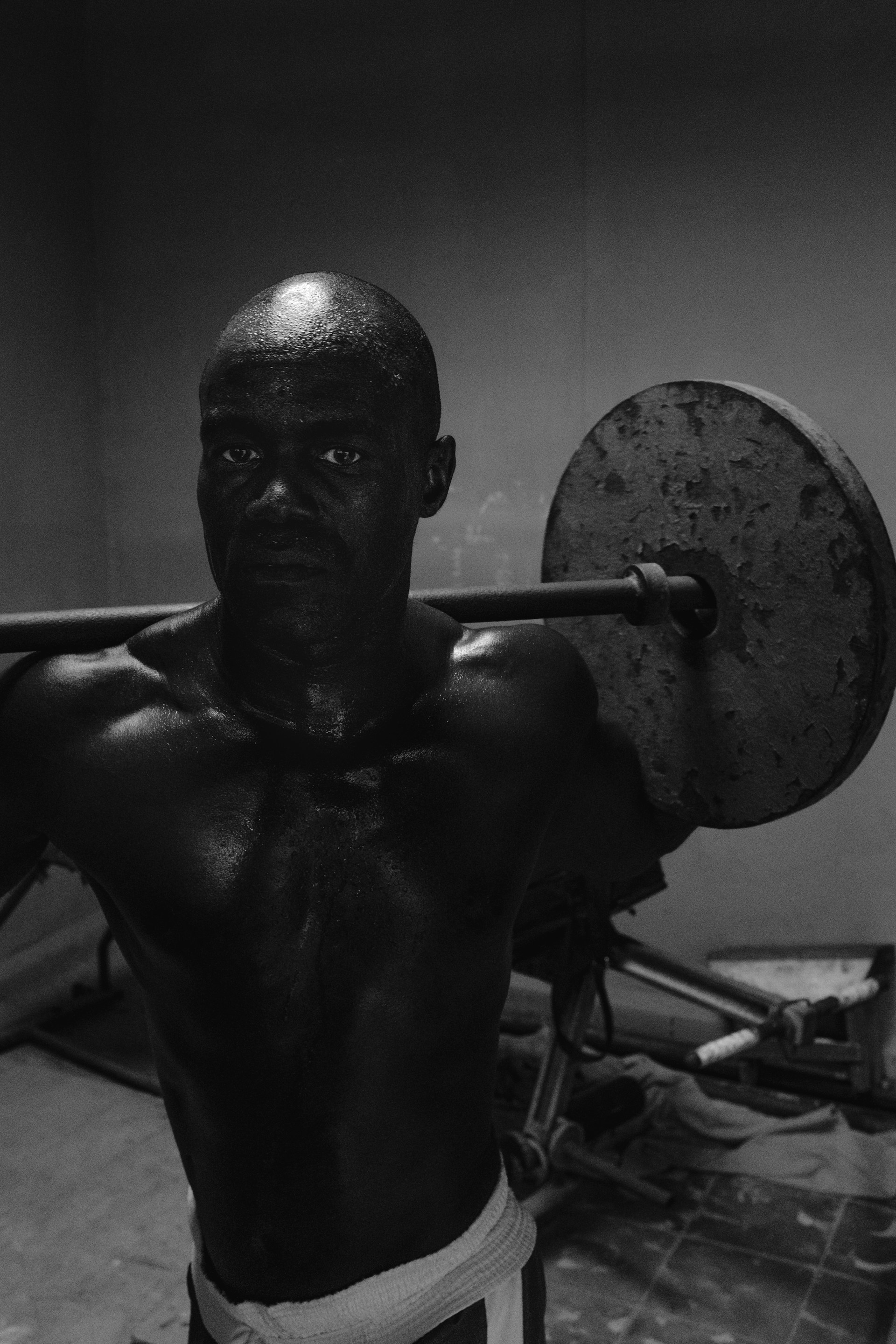 a man with a barbell on his shoulder