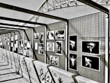 a black and white photo of a wall with pictures on it