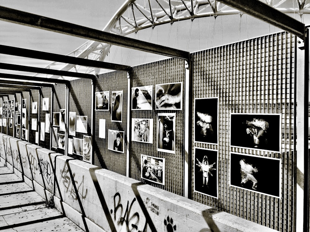 a black and white photo of a wall with pictures on it