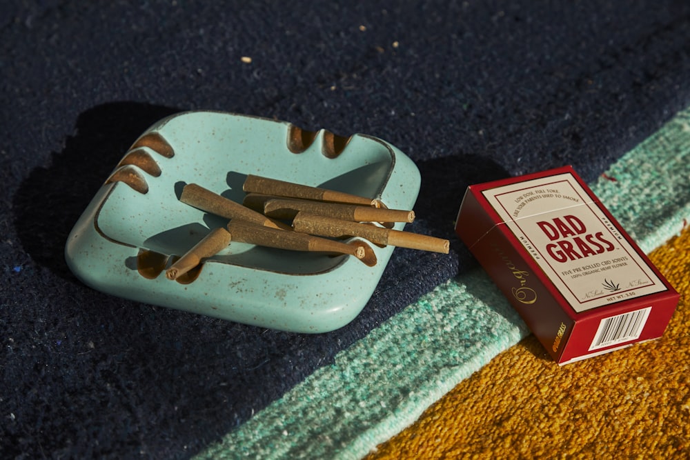 a box of cigarettes sitting next to a ashtray