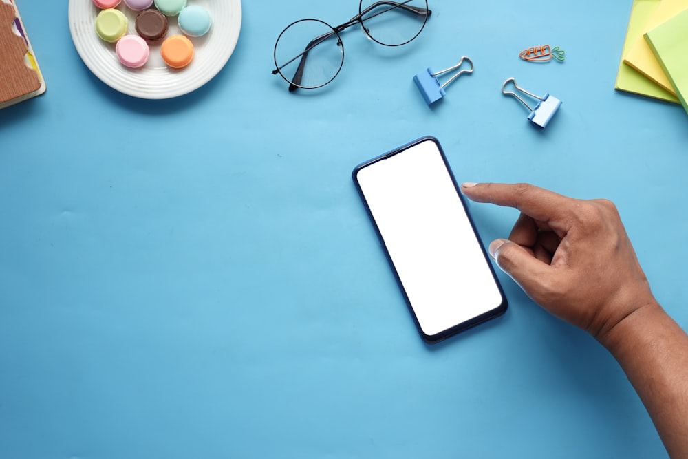 a person using a cell phone on a table