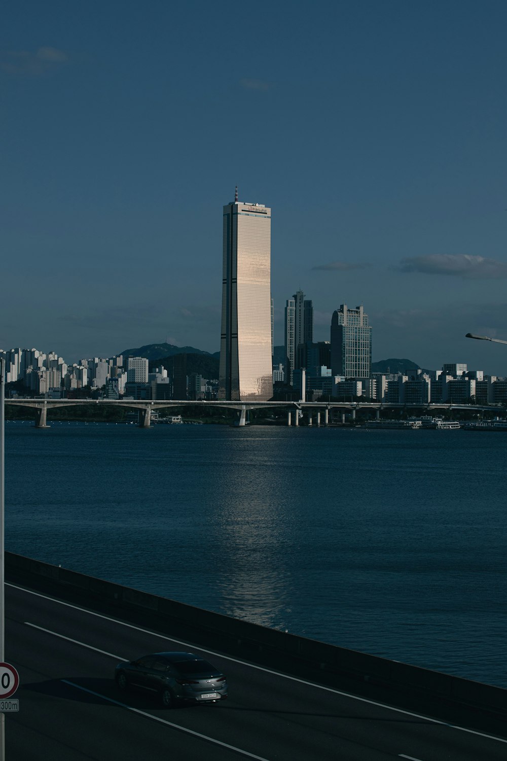 a large body of water with a city in the background