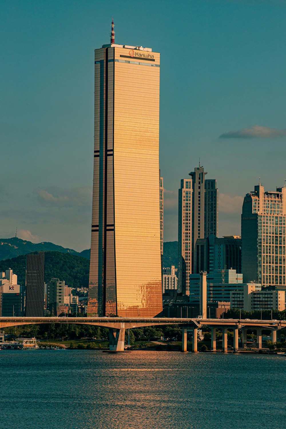 a city skyline with a bridge crossing over a body of water