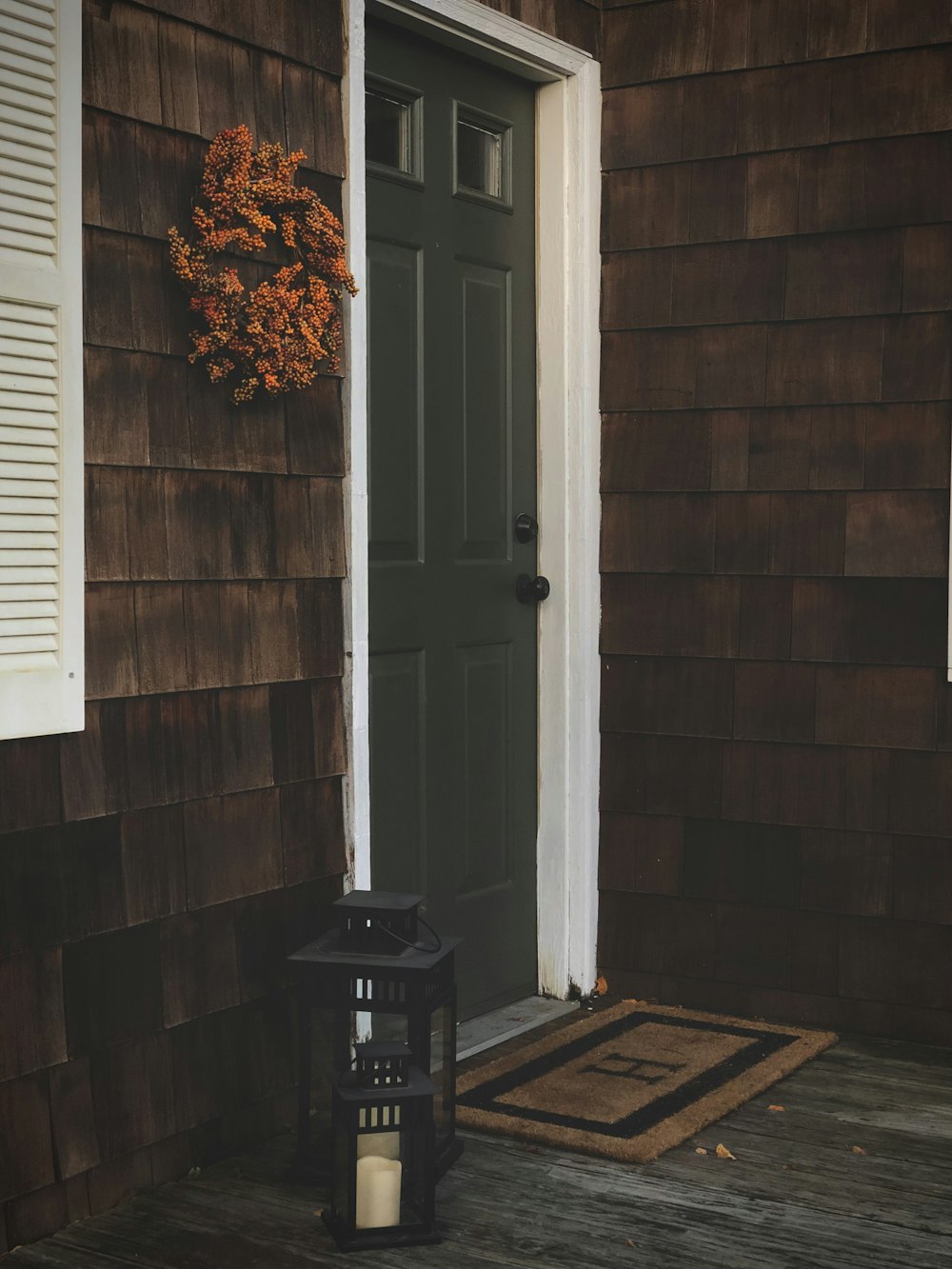 a lantern sitting on a porch next to a door