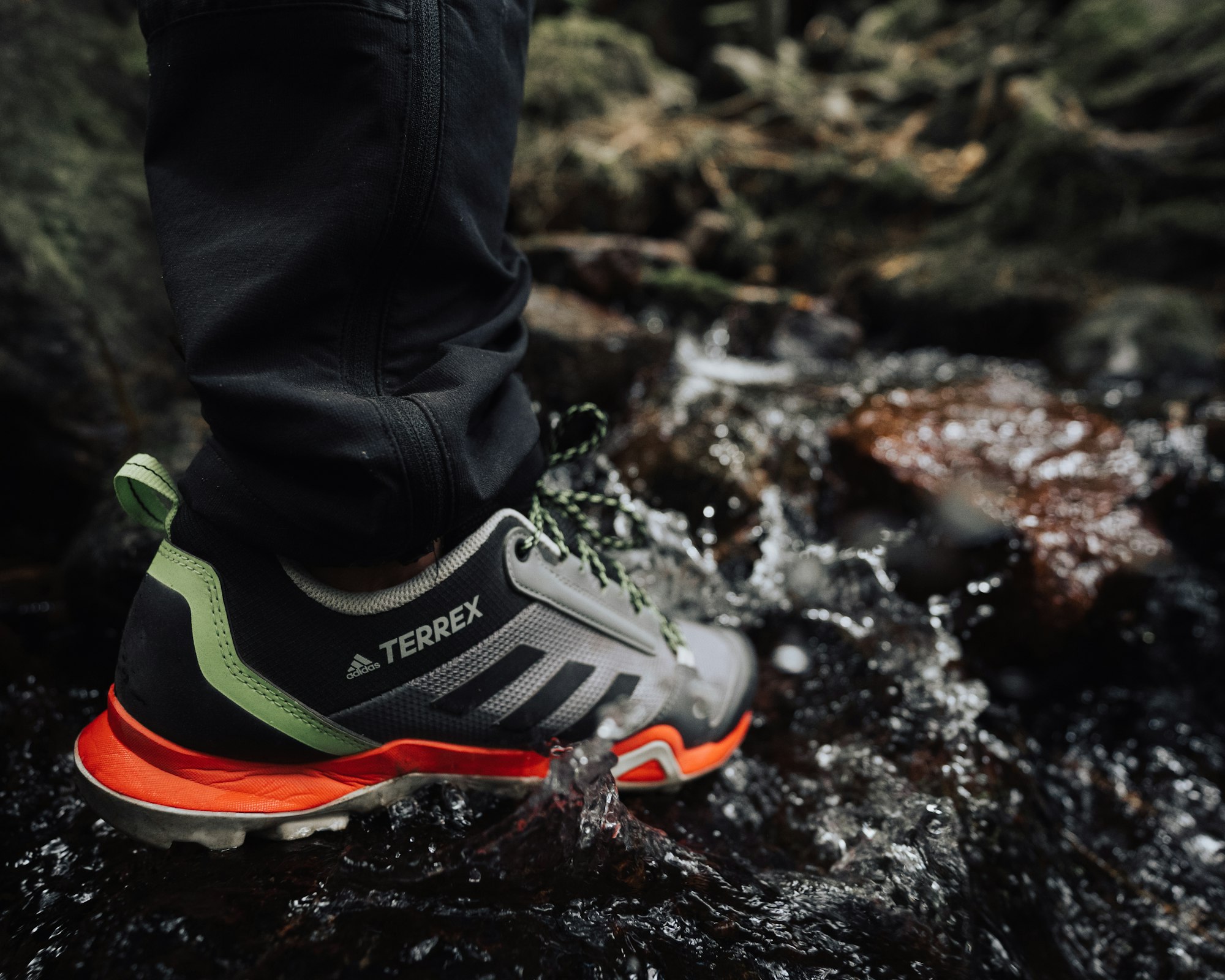 a close up of a person's feet in water -gore tex -best disc golf shoes for wide feet