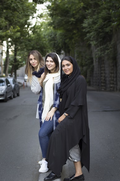 a group of three women standing next to each other