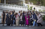 A group of women showcasing various stylish outfits outdoors.