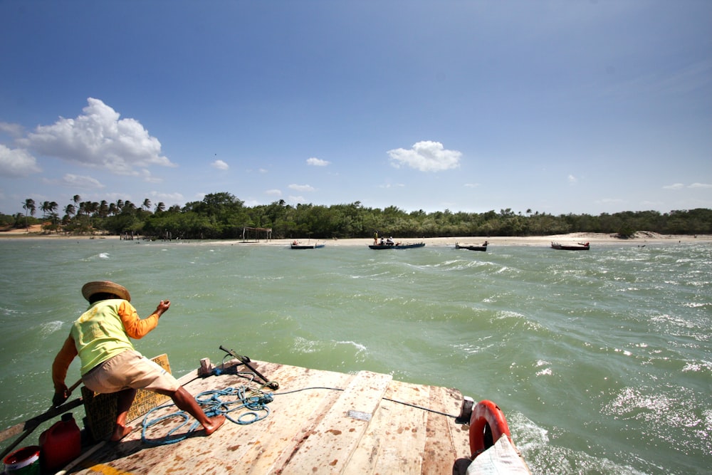 a man riding a boat on top of a body of water