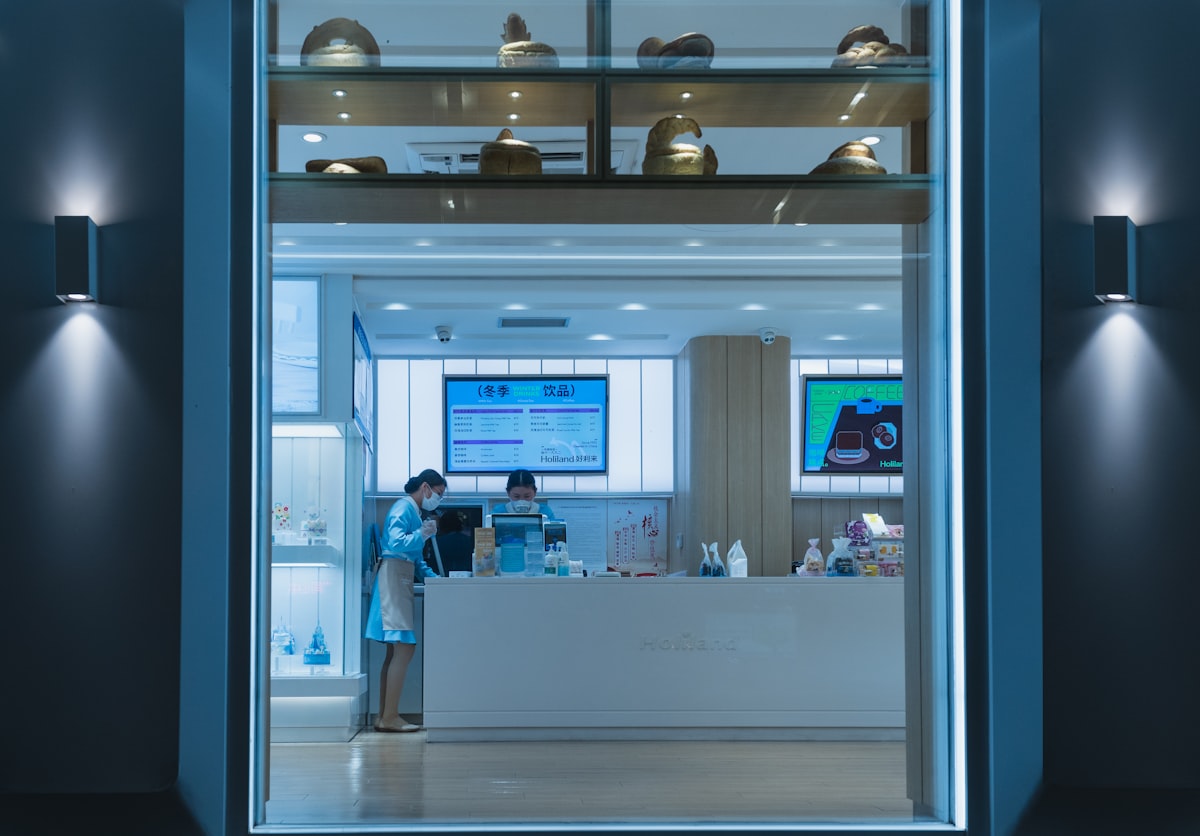 Two people standing at a clinic reception counter