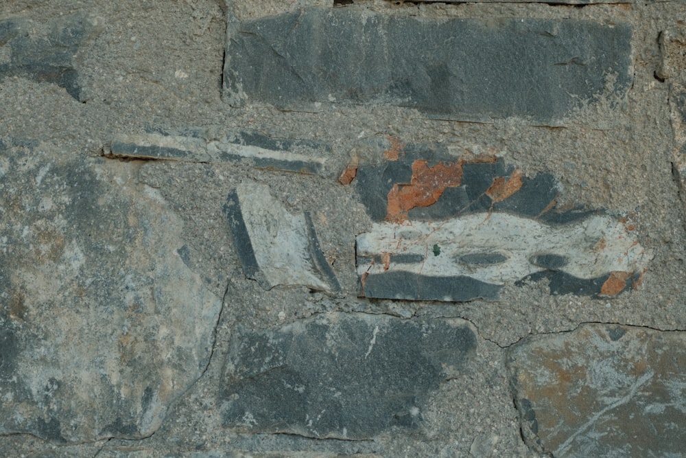 a rock wall with a piece of paper on it