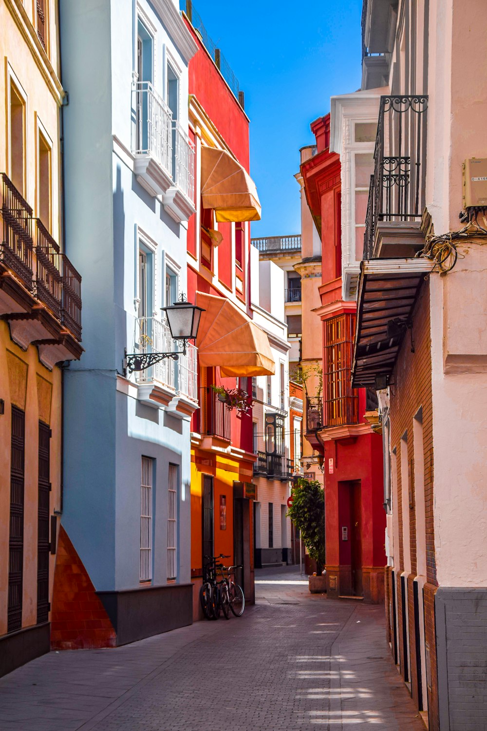 a narrow city street lined with tall buildings