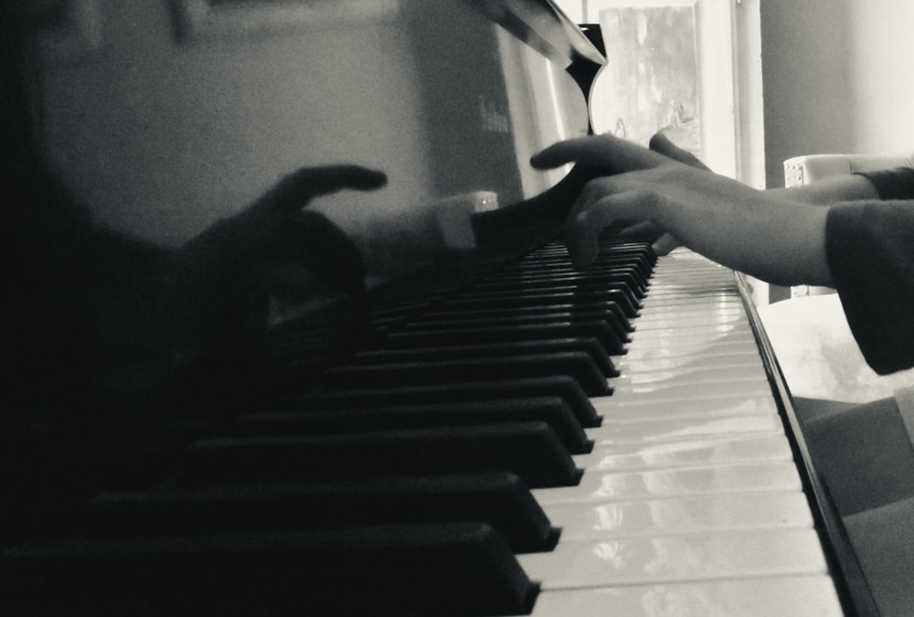 a person is playing the piano with their hands