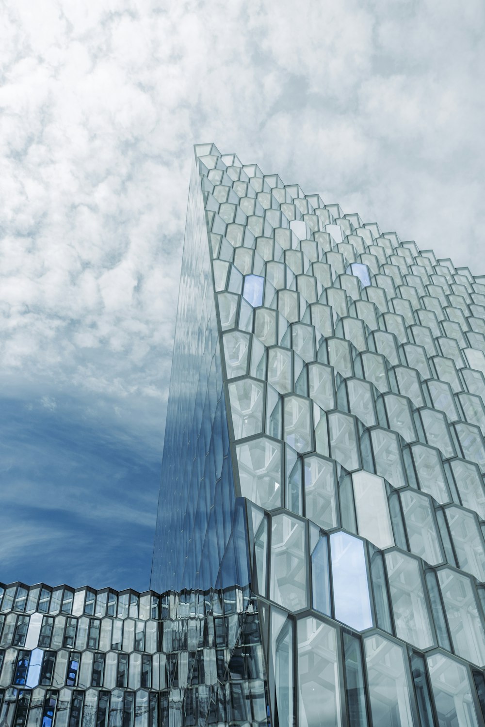 a very tall building with many windows and a sky background