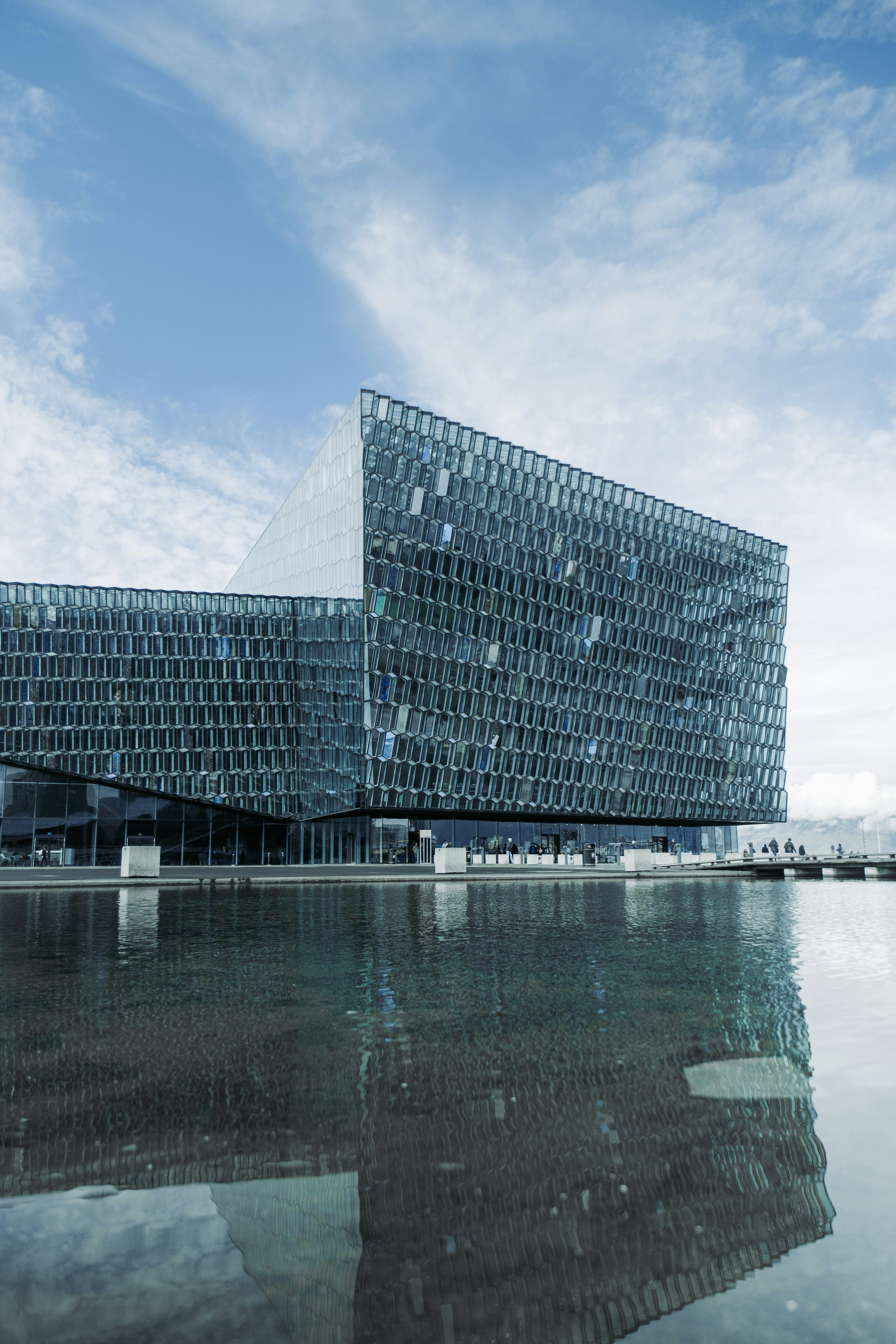 A very large building that is next to a body of water photo – Free ...