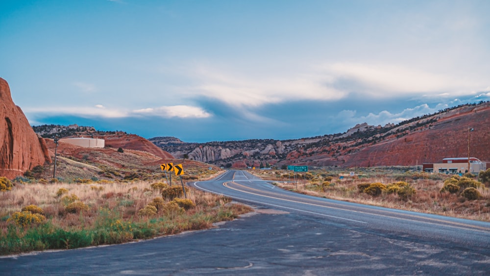 an empty road in the middle of the desert