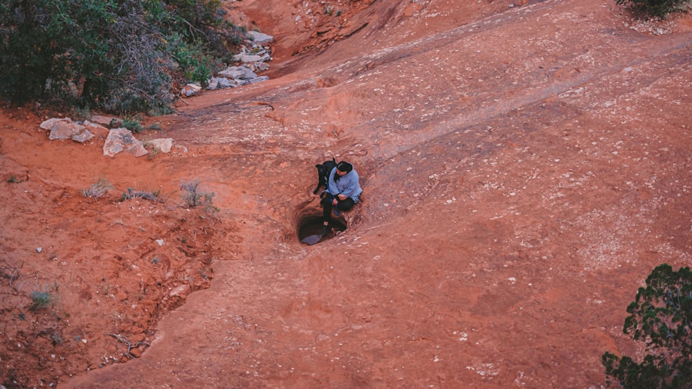 a man riding a motorcycle down a dirt road