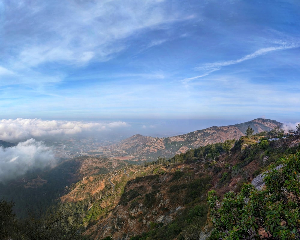 a scenic view of a mountain range with clouds in the sky