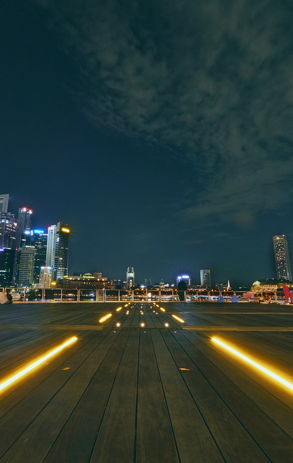 an airport runway at night with buildings in the background