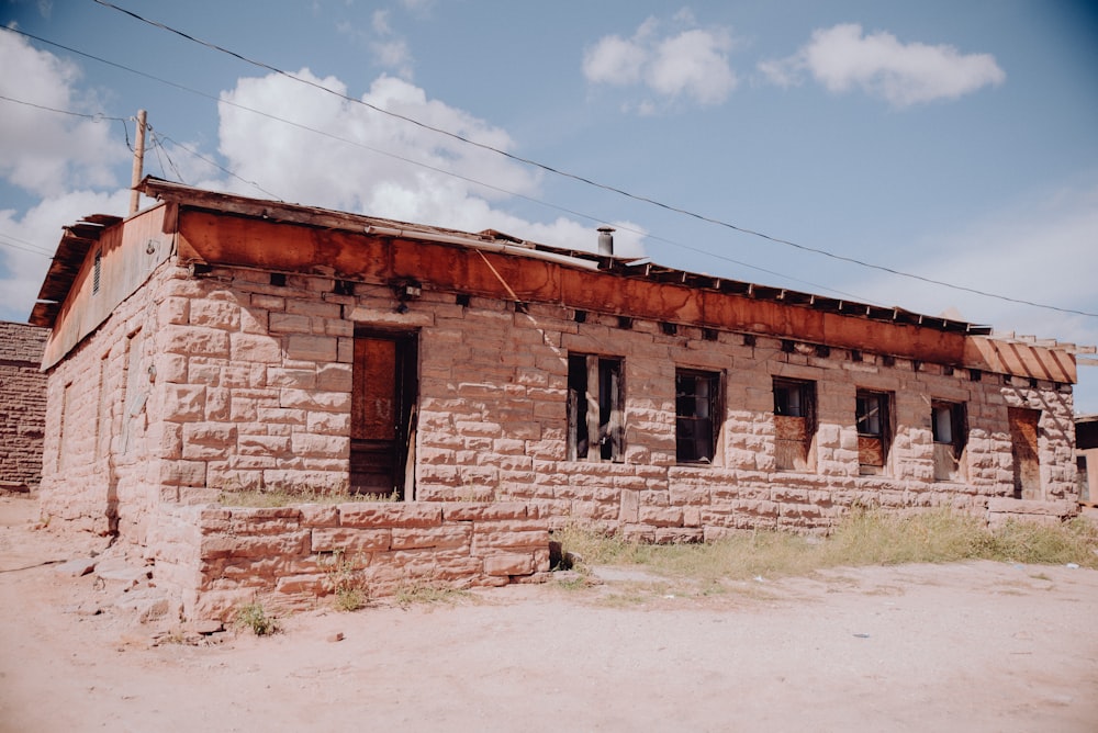 an old brick building with a rusty roof