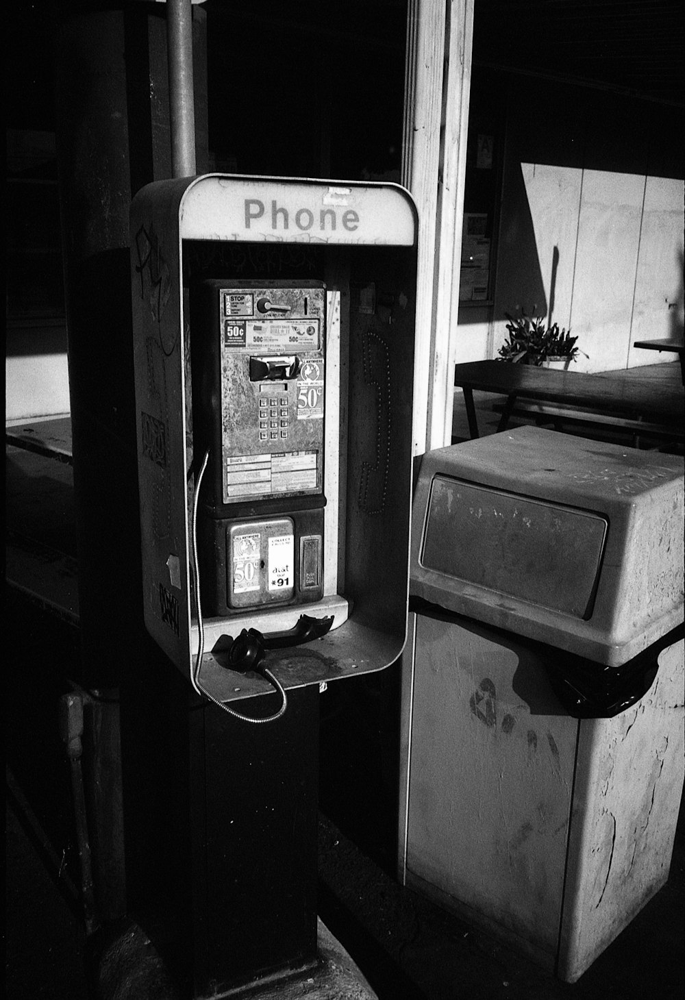 a black and white photo of an old phone