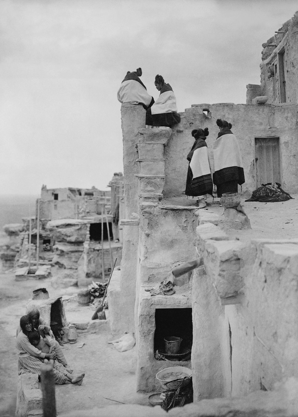 a group of people sitting on top of a building