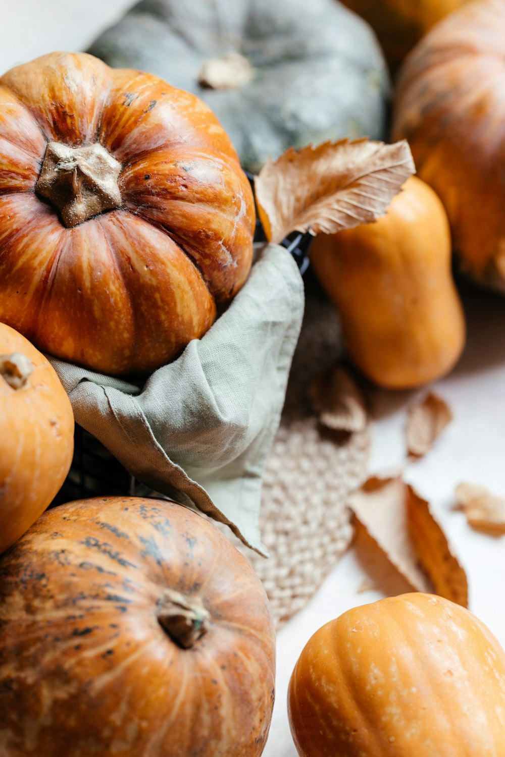 a pile of pumpkins sitting on top of a table