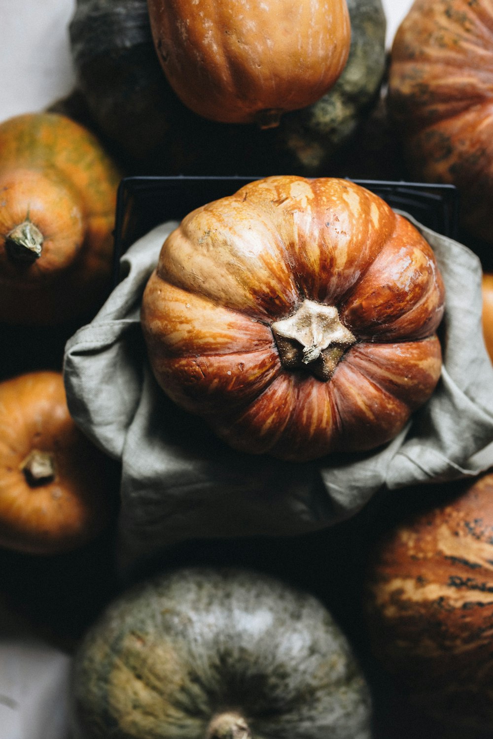 a pile of pumpkins sitting on top of a table