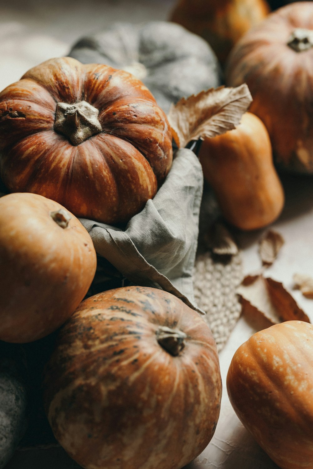 a pile of pumpkins sitting on top of a table