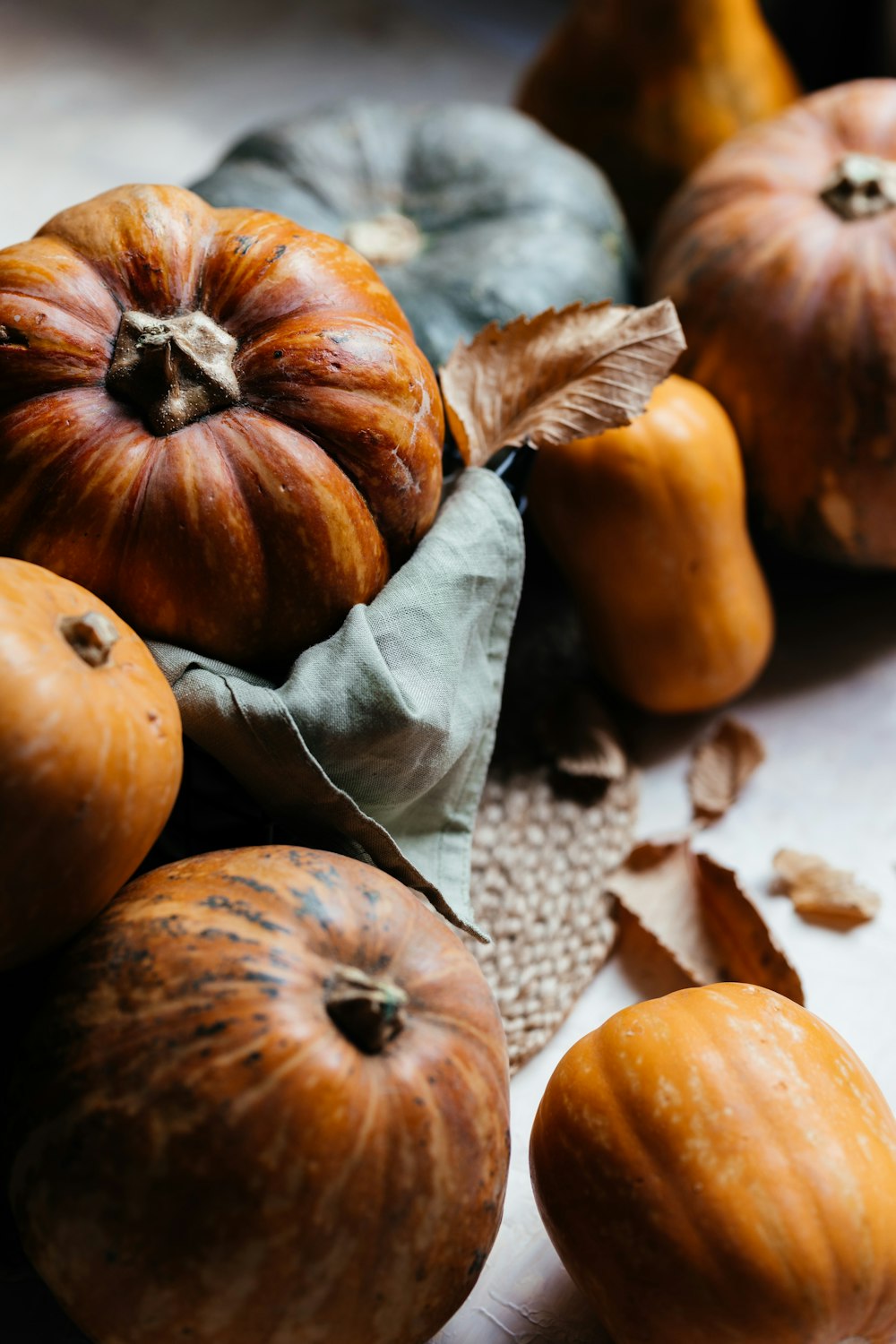 a pile of pumpkins sitting on top of a table