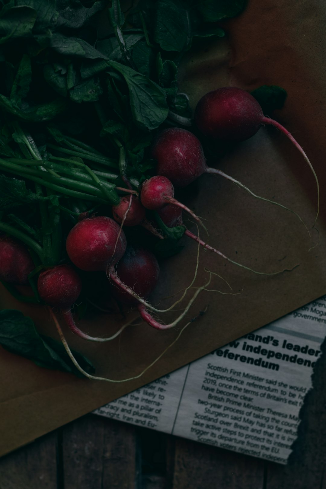 a bunch of radishes sitting on top of a brown paper bag