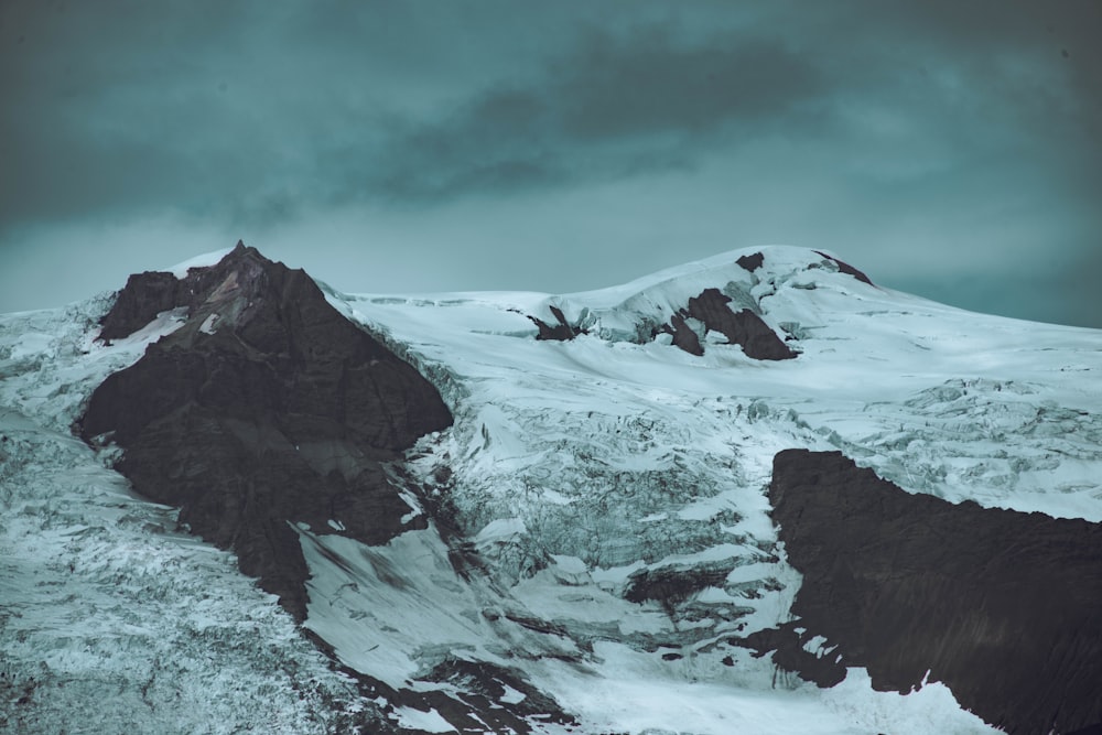 a man riding on top of a snow covered mountain