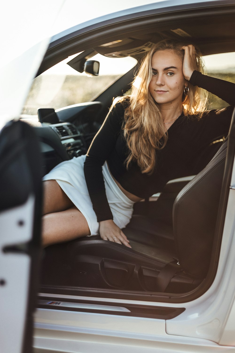 a woman sitting in the back seat of a car