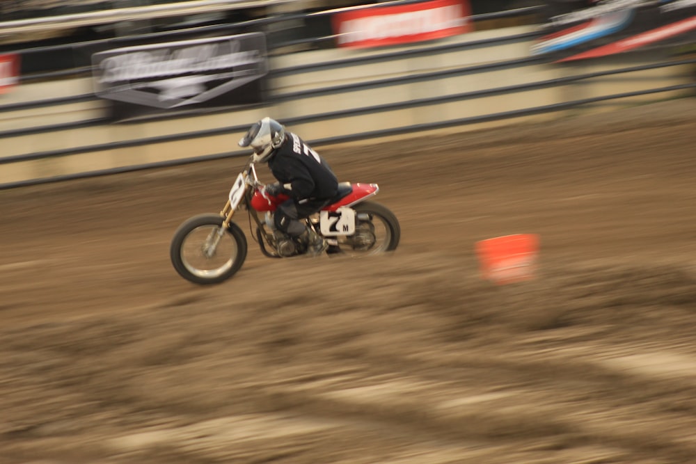 a man riding a dirt bike on top of a dirt field