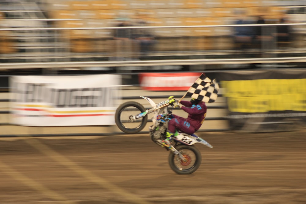 a man riding a dirt bike on top of a dirt field