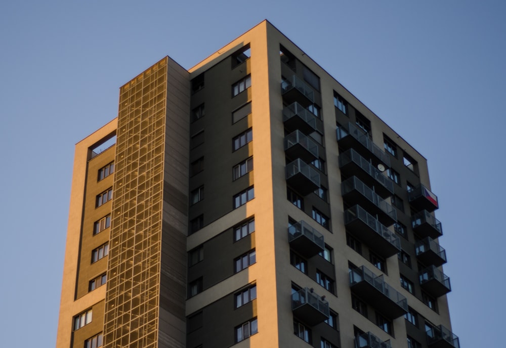 a tall building with balconies on top of it