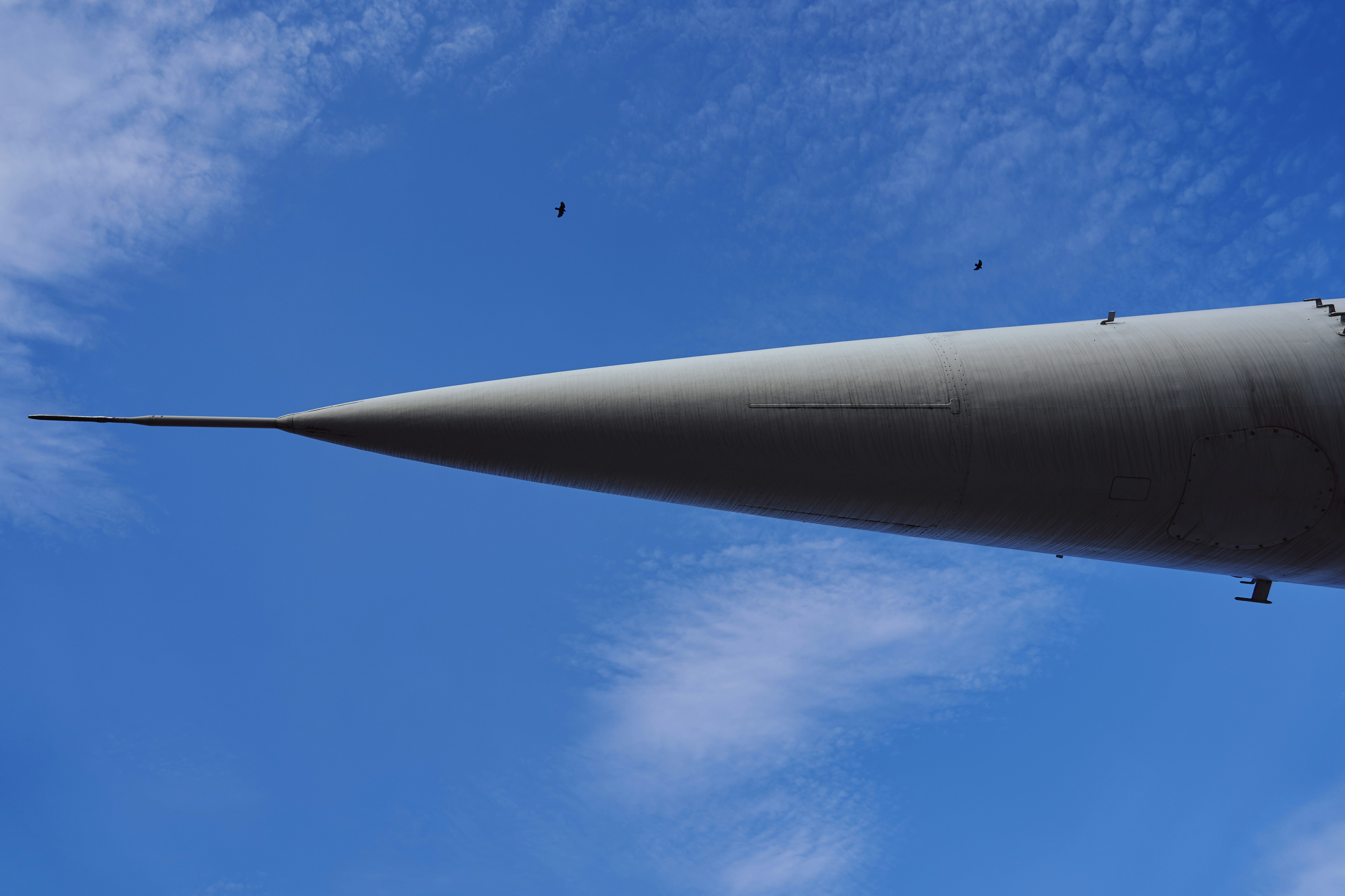 a large jetliner flying through a blue sky