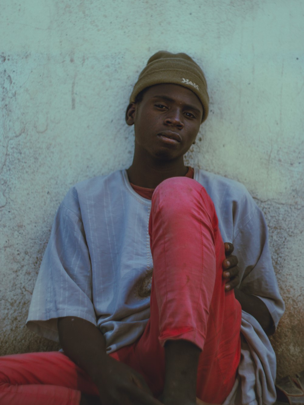 a man sitting on the ground with his legs crossed