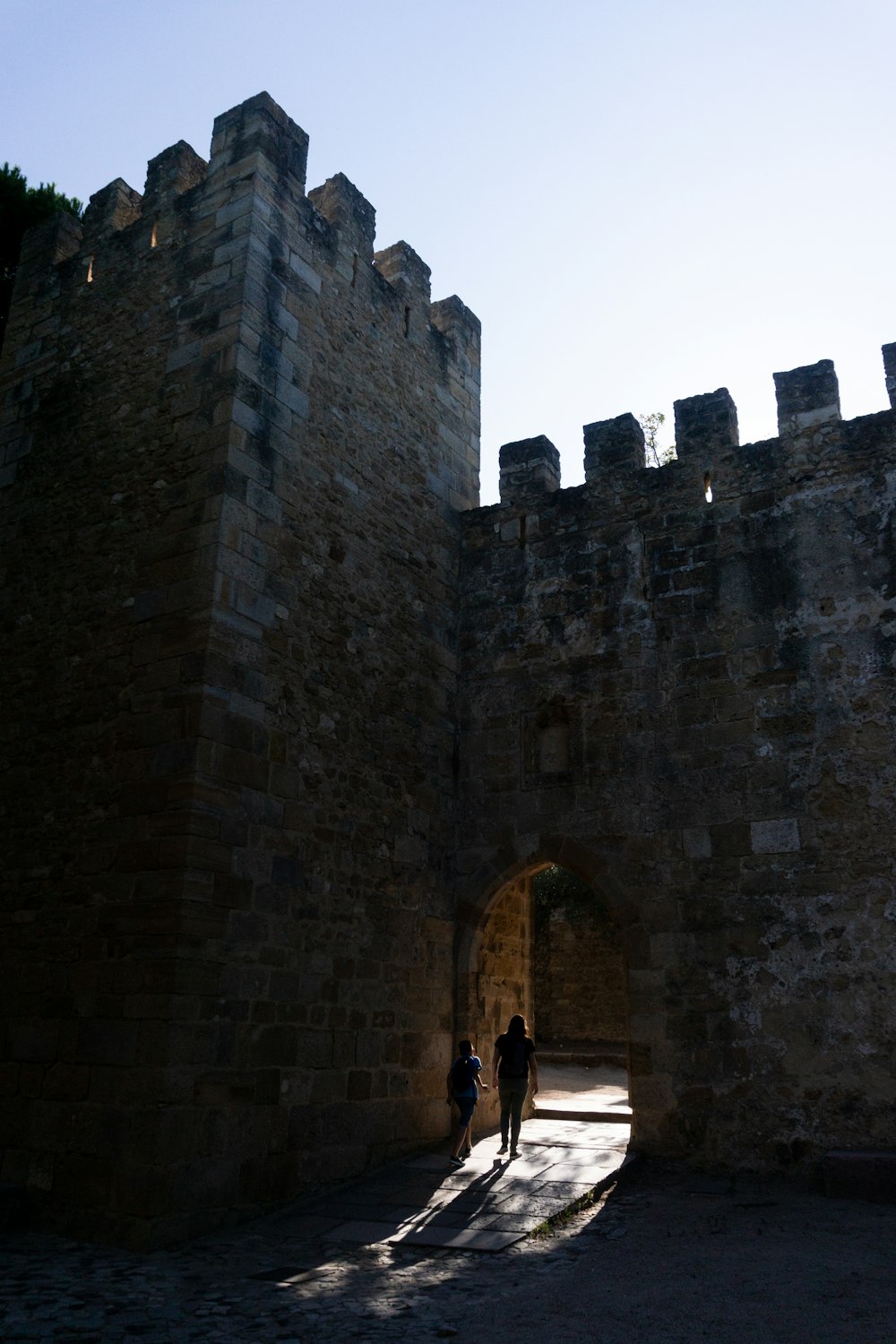 a couple of people that are standing in front of a castle