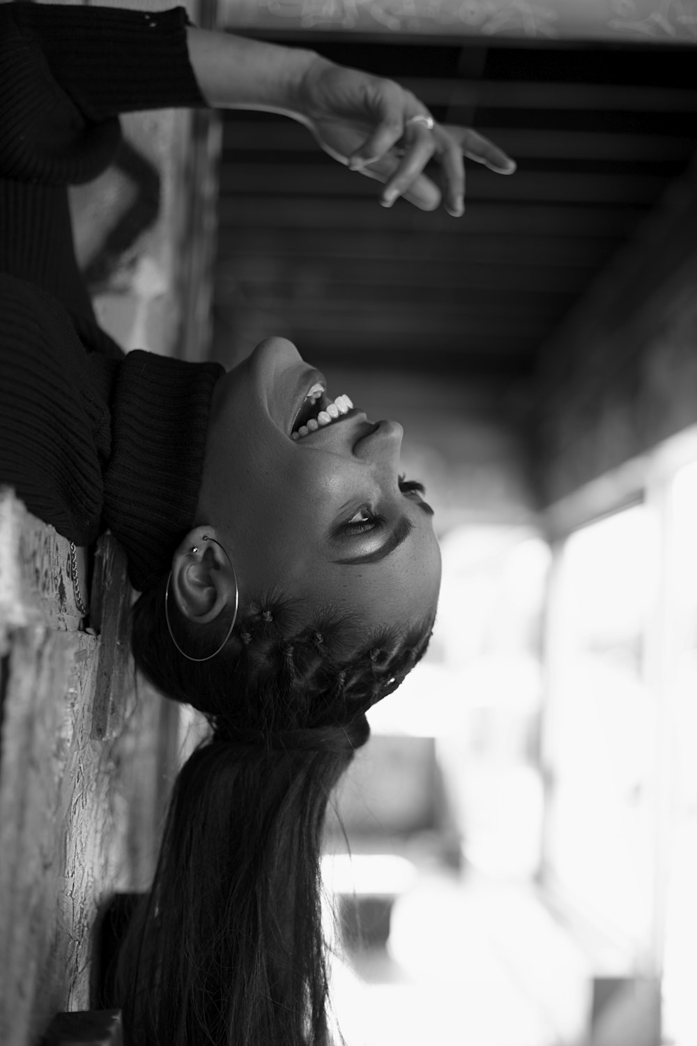 a black and white photo of a woman smiling