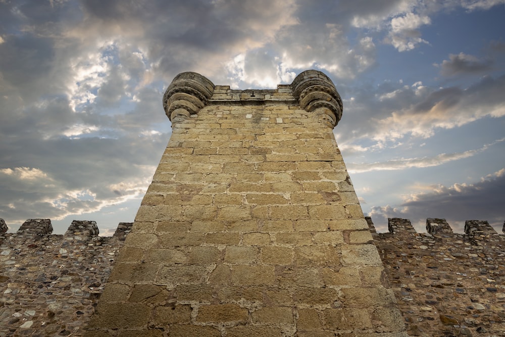 a tall brick tower with a sky in the background