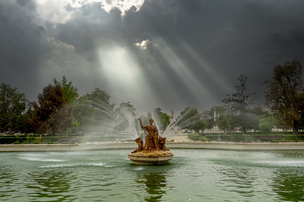 a fountain with a statue in the middle of it