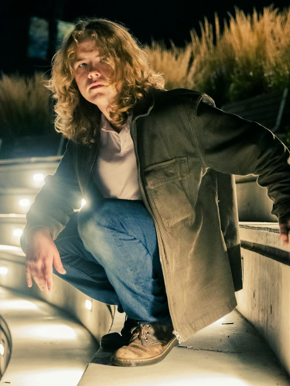 a man sitting on a bench with his hand on his hip