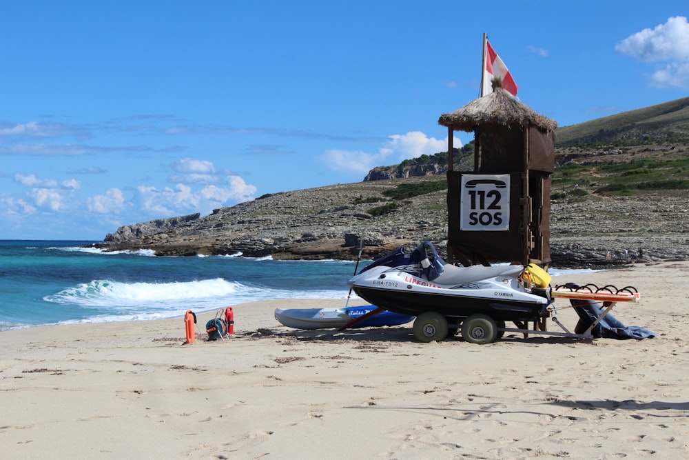 a boat on a trailer on a beach near the ocean