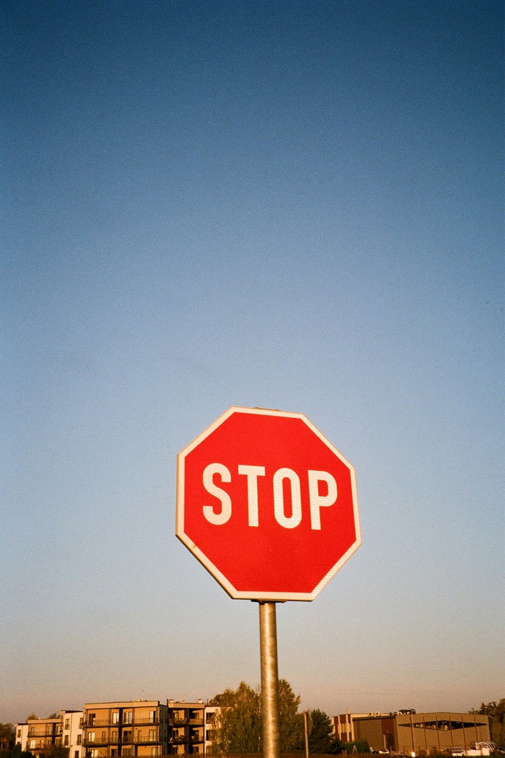 a red stop sign sitting on the side of a road