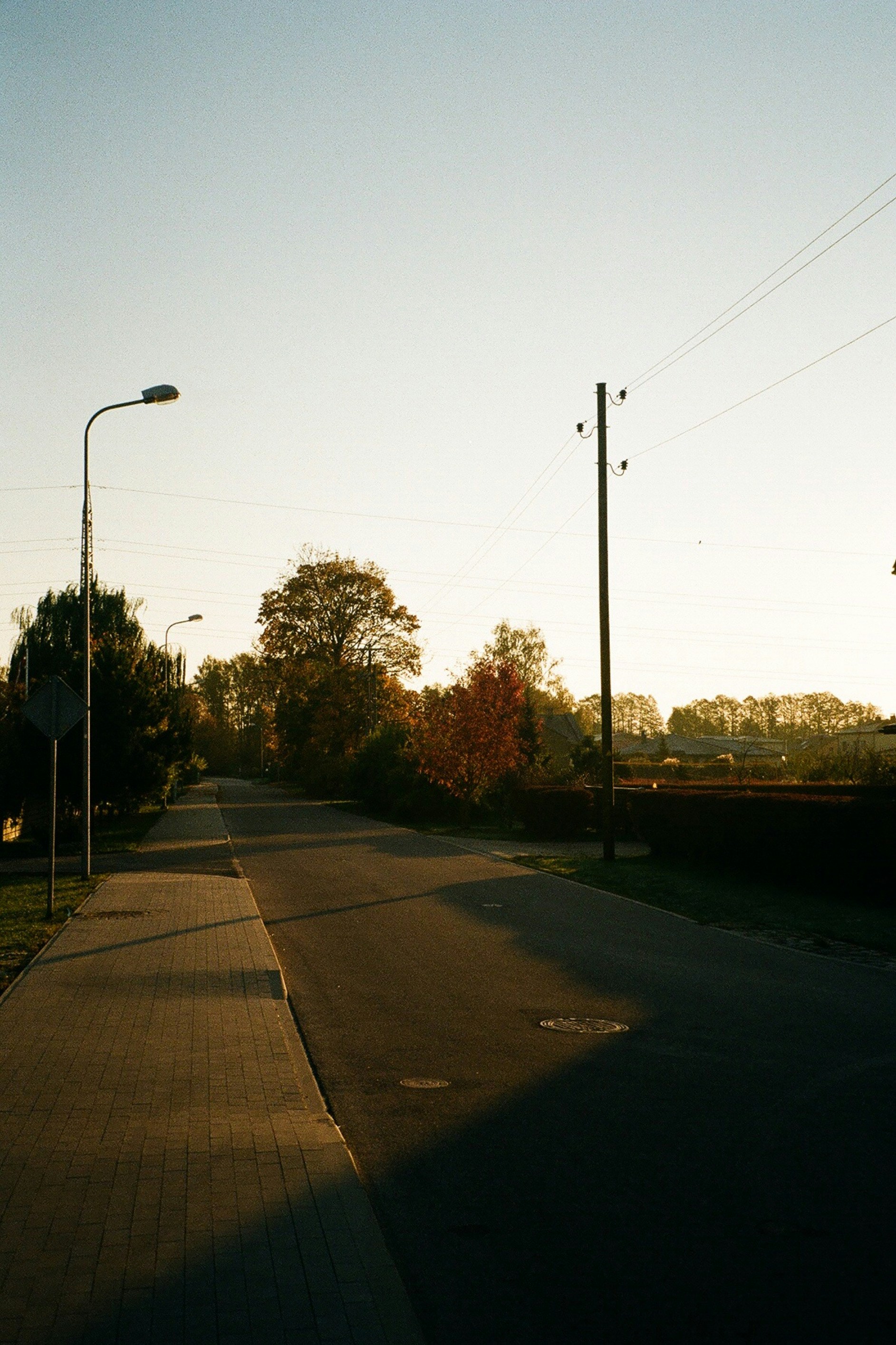 a street with a street light and a street sign