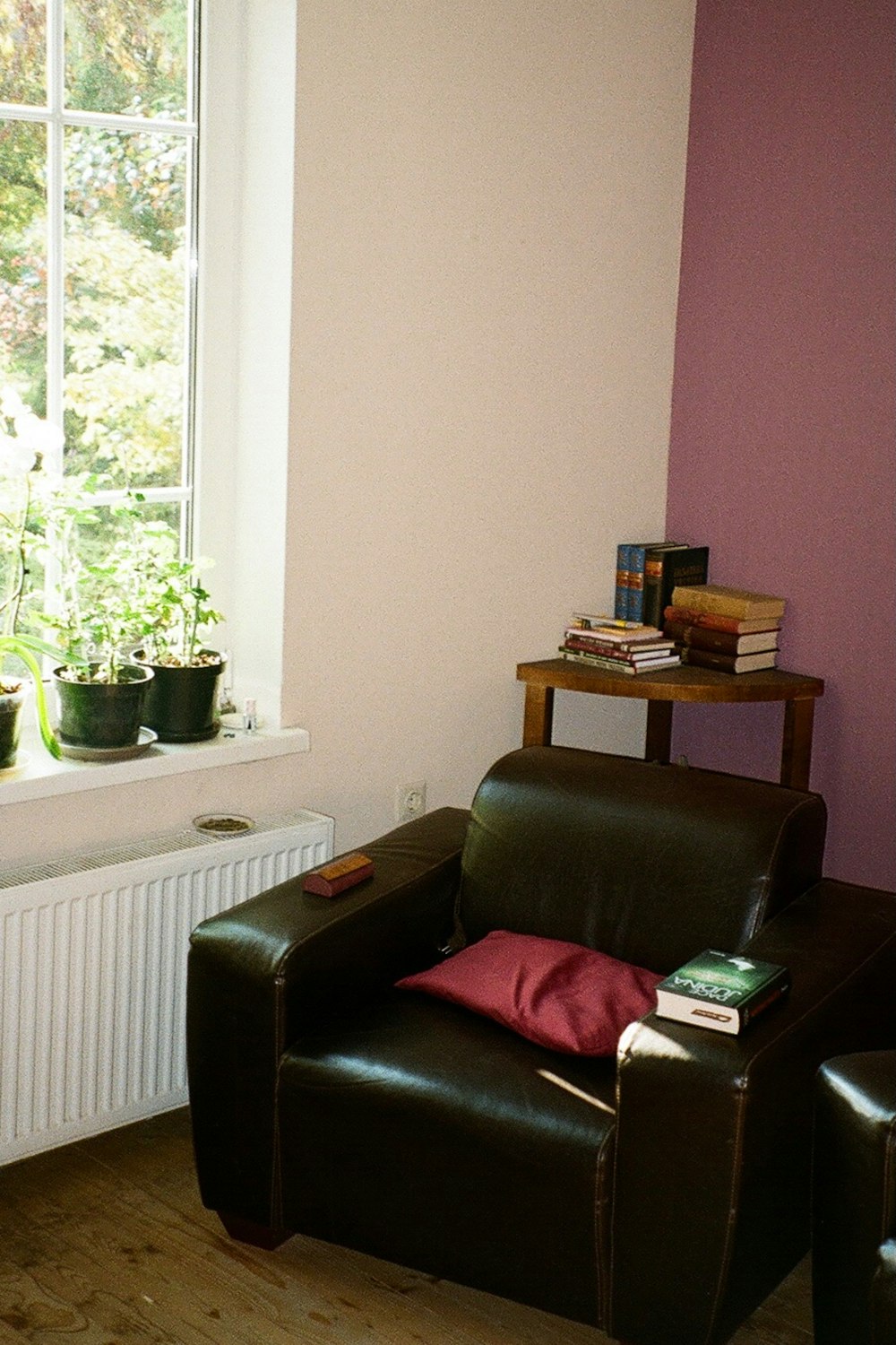 a living room with a chair and a radiator