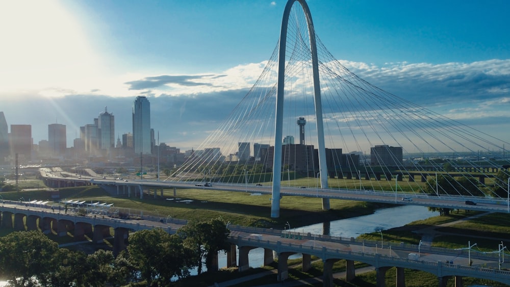 a bridge over a river with a city in the background