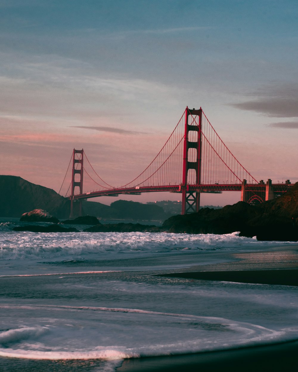 a view of the golden gate bridge from the beach